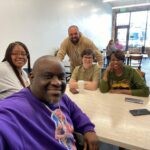 Pastor Mike mcbride sitting with allies in the fight against gun violence and implementing community-based gun violence prevention
